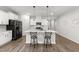 Bright kitchen featuring white cabinetry, a center island with pendant lighting and seating, and stainless steel appliances at 159 Clear Water Rd, Louisburg, NC 27549