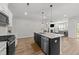 Modern kitchen with a center island, stainless appliances, and lots of natural light at 159 Clear Water Rd, Louisburg, NC 27549