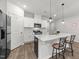 Bright kitchen boasts a center island, stainless appliances, and white cabinetry at 159 Clear Water Rd, Louisburg, NC 27549