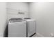 Laundry room featuring modern washer and dryer units with a wire shelf above at 159 Clear Water Rd, Louisburg, NC 27549