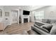 Bright living room features a fireplace, decorative mantle, and comfortable gray couch at 159 Clear Water Rd, Louisburg, NC 27549
