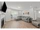 Inviting living room with a large sectional couch, fireplace, and ample natural light at 159 Clear Water Rd, Louisburg, NC 27549
