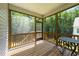 Relaxing screened porch features a wood deck and a peaceful view of the wooded backyard at 159 Clear Water Rd, Louisburg, NC 27549