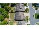 Aerial view of the backyard showcasing the landscaping and proximity to neighboring houses and street at 1600 Drift Falls Ln, Wendell, NC 27591