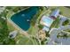 Aerial shot featuring a community area with a lake, pool, playground, and surrounding greenery at 1600 Drift Falls Ln, Wendell, NC 27591