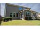 View of the home's backyard with a screened porch and well-maintained lawn at 1600 Drift Falls Ln, Wendell, NC 27591