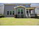 A well-maintained backyard with gray siding and a screened porch, perfect for outdoor relaxation at 1600 Drift Falls Ln, Wendell, NC 27591