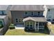 Aerial view of a backyard with a concrete patio and screened porch, set in a serene neighborhood at 1600 Drift Falls Ln, Wendell, NC 27591