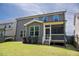 View of the home's backyard with a screened porch and well-maintained lawn at 1600 Drift Falls Ln, Wendell, NC 27591