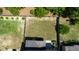 Aerial of backyard featuring a large, fenced lawn, garden beds, and patio with outdoor seating at 1600 Drift Falls Ln, Wendell, NC 27591