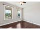 Bright bedroom features two windows and dark wood floors, offering a comfortable and inviting space at 1600 Drift Falls Ln, Wendell, NC 27591