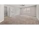 Spacious bedroom with plush carpet, ceiling fan, and natural light from window at 1600 Drift Falls Ln, Wendell, NC 27591
