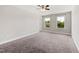 Spacious bedroom with neutral walls, carpet, ceiling fan and two windows that allow natural light at 1600 Drift Falls Ln, Wendell, NC 27591