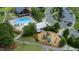 Aerial of community amenities including a swimming pool, playground, and clubhouse with mature trees at 1600 Drift Falls Ln, Wendell, NC 27591