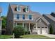 Traditional home featuring brick and siding, complemented by a well-manicured lawn and inviting front porch at 1600 Drift Falls Ln, Wendell, NC 27591