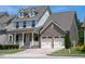 Charming two-story home with a welcoming front porch and a two-car garage at 1600 Drift Falls Ln, Wendell, NC 27591