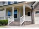 A brick front porch with white railings and columns at 1600 Drift Falls Ln, Wendell, NC 27591