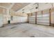 Spacious garage with two doors, concrete floor, and exposed ceiling, great for storage and parking at 1600 Drift Falls Ln, Wendell, NC 27591