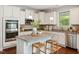 Modern kitchen with granite countertops, stainless steel appliances, and a center island with seating at 1600 Drift Falls Ln, Wendell, NC 27591