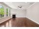 Open living room with hardwood floors, a fireplace, and abundant natural light at 1600 Drift Falls Ln, Wendell, NC 27591