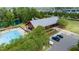 An aerial view of community center with a pool, lake, parking and green spaces with mature trees at 1600 Drift Falls Ln, Wendell, NC 27591
