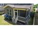 View of screened porch with wood railing and steps, offering a cozy outdoor space for relaxation at 1600 Drift Falls Ln, Wendell, NC 27591