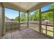 Open screened porch with wood flooring and peaceful views of the backyard at 1600 Drift Falls Ln, Wendell, NC 27591