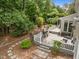 Aerial view of landscaped backyard with a deck, grill, and stone pathway for outdoor living at 18 Acornridge Ct, Durham, NC 27707