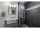Modern bathroom featuring glass shower with unique tile accent and vanity sink at 18 Acornridge Ct, Durham, NC 27707