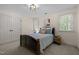 Bedroom featuring a dark wood bed, large windows, and closet at 18 Acornridge Ct, Durham, NC 27707