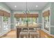 Bright dining area with table, stools, chandelier and plenty of natural light at 18 Acornridge Ct, Durham, NC 27707