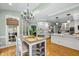 Bright eat-in kitchen boasts table, stools, chandelier and plenty of natural light at 18 Acornridge Ct, Durham, NC 27707