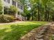 Traditional two-story home with black shutters, nestled among mature trees and meticulously manicured lawn at 18 Acornridge Ct, Durham, NC 27707