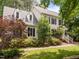 Traditional two-story home with black shutters, nestled among mature trees and meticulous landscaping at 18 Acornridge Ct, Durham, NC 27707
