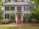 Charming two-story home with black shutters and a red front door at 18 Acornridge Ct, Durham, NC 27707