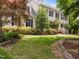 Traditional two-story home with black shutters, nestled among mature trees and meticulous landscaping at 18 Acornridge Ct, Durham, NC 27707