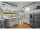 A bright eat-in kitchen features stainless appliances, white cabinets, and granite countertops at 18 Acornridge Ct, Durham, NC 27707