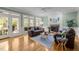 Living room offers fireplace, hardwood floors, and access to the sunroom at 18 Acornridge Ct, Durham, NC 27707
