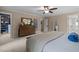 A nicely decorated main bedroom with neutral colors, carpet, ceiling fan, and ensuite closet and bathroom at 18 Acornridge Ct, Durham, NC 27707