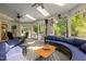Spacious screened-in porch with comfortable seating, skylights, and ceiling fans for outdoor relaxation at 18 Acornridge Ct, Durham, NC 27707