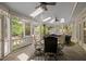 Enclosed porch featuring skylights, ceiling fans, and comfortable seating for relaxing and entertaining guests at 18 Acornridge Ct, Durham, NC 27707