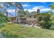 Expansive backyard featuring well-maintained lawn, mature trees, and a two-story home with a brick facade at 1920 Hillock Dr, Raleigh, NC 27612