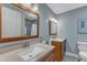 Bright bathroom featuring double vanities, framed mirrors, and a tiled shower/tub at 1920 Hillock Dr, Raleigh, NC 27612