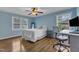 This light and airy bedroom features two windows, wood flooring, and a desk for convenient work at 1920 Hillock Dr, Raleigh, NC 27612