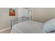 Bedroom with a metal bed frame and palm tree art hanging on the wall at 1920 Hillock Dr, Raleigh, NC 27612