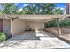 Attached carport with a concrete floor, storage area, and access door, offering convenient parking and storage at 1920 Hillock Dr, Raleigh, NC 27612