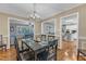 The Dining Room features hardwood floors, a modern chandelier, and views into the kitchen and living room at 1920 Hillock Dr, Raleigh, NC 27612