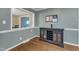 Dining room featuring hardwood floors, a built-in wine rack, and a pass-through to an adjacent room at 1920 Hillock Dr, Raleigh, NC 27612