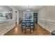 Traditional dining room featuring hardwood floors, contemporary lighting, and a modern table setting at 1920 Hillock Dr, Raleigh, NC 27612