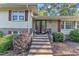 Home's brick front entrance and decorative plants are inviting at 1920 Hillock Dr, Raleigh, NC 27612